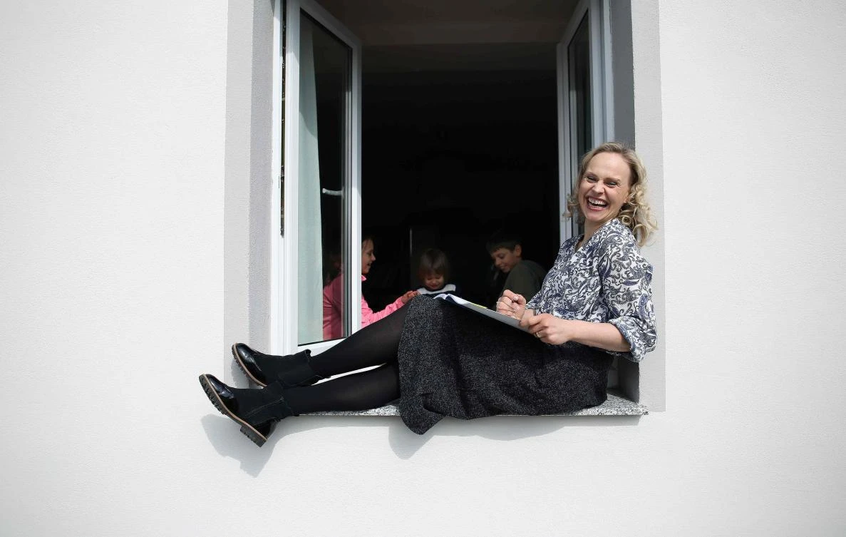 German sopranist and member of the ensemble of Leipzig's opera house (Oper Leipzig), Lilli Wuenscher poses at the window of her home, where she stays confined with her family due to the pandemic of the novel coronavirus, on April 3, 2020 on the outskirts of Leipzig, eastern Germany. The gates of the Leipzig Opera have been closed for about three weeks due to the novel corona pandemic - but the voices and instruments of the artists are far from silent. / AFP / Ronny Hartmann