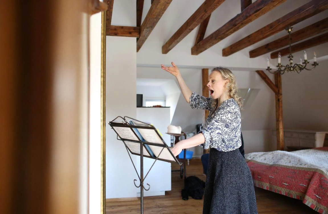 German sopranist and member of the ensemble of Leipzig's opera house (Oper Leipzig), Lilli Wuenscher sings at home, where she stays confined with her family due to the pandemic of the novel coronavirus, on April 3, 2020 on the outskirts of Leipzig, eastern Germany. The gates of the Leipzig Opera have been closed for about three weeks due to the novel corona pandemic - but the voices and instruments of the artists are far from silent. / AFP / Ronny Hartmann