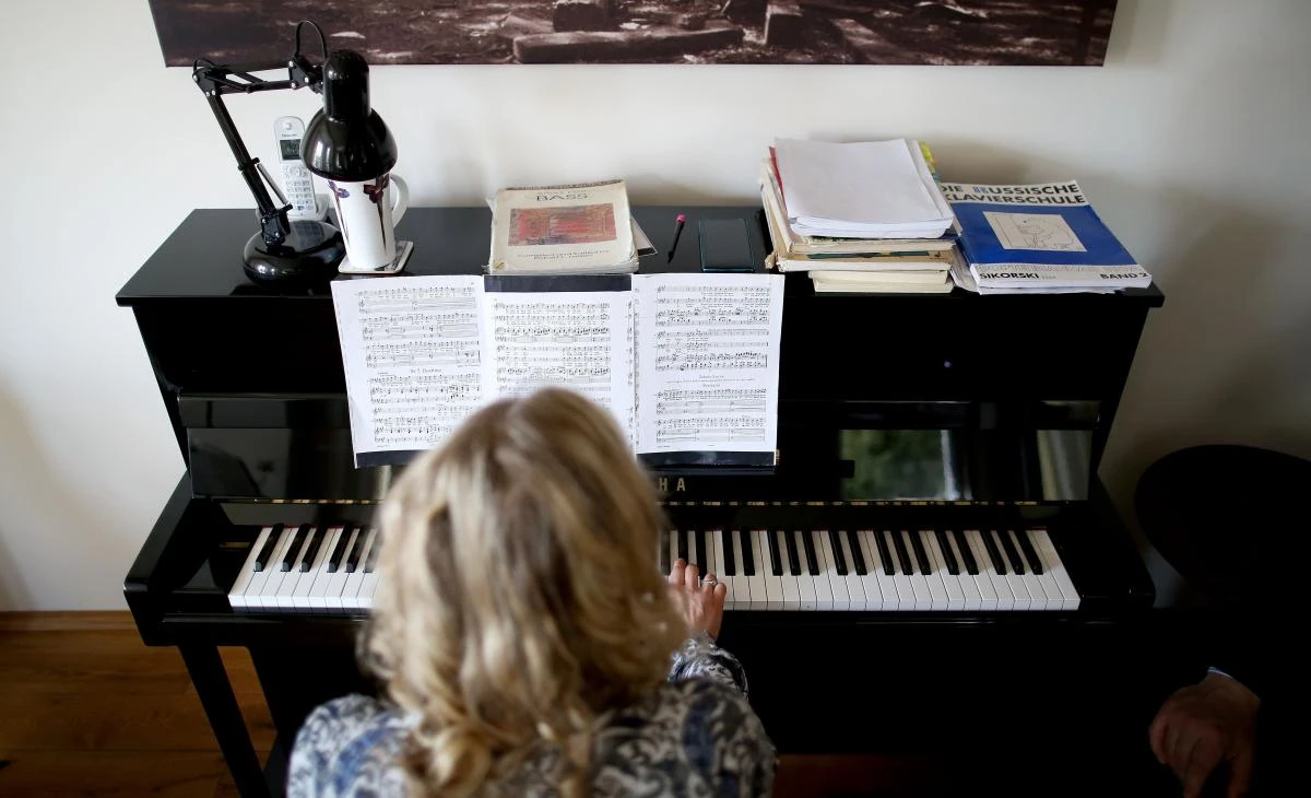 German sopranist and member of the ensemble of Leipzig's opera house (Oper Leipzig), Lilli Wuenscher sings at home, where she stays confined with her family due to the pandemic of the novel coronavirus, on April 3, 2020 on the outskirts of Leipzig, eastern Germany. The gates of the Leipzig Opera have been closed for about three weeks due to the novel corona pandemic - but the voices and instruments of the artists are far from silent. / AFP / Ronny Hartmann