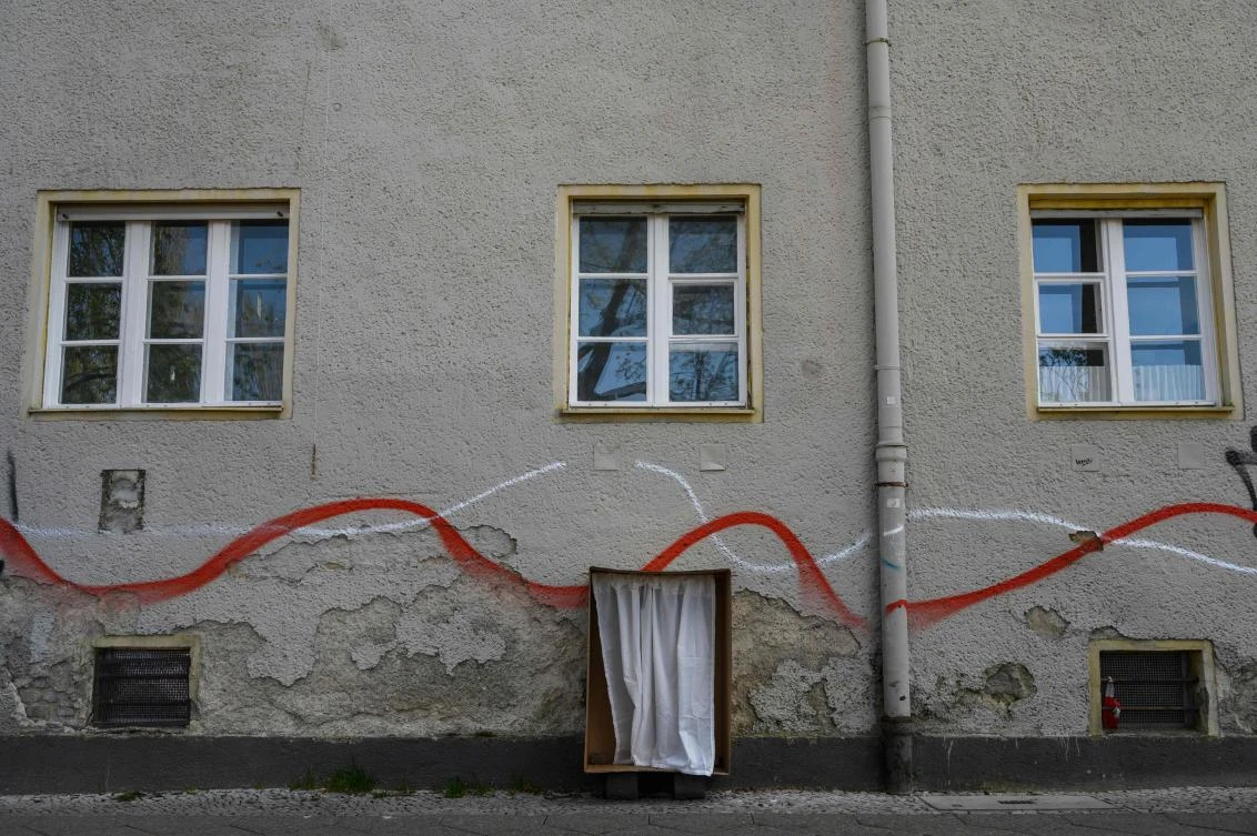 An art installation featuring a balcony made of cardboard, part of the "Balconies, Life, Art, Pandemic, and Proximity" exhibition, is seen in Berlin on April 12, 2020, amid a new coronavirus COVID-19 pandemic. Over 30 artists are taking part in the two-day exhibition which calls on "the artistic community living in [Berlin's district of] Prenzlauer Berg to activate / exhibit / inhabit / their windows and balconies on Easter Sunday and Monday". Curated by Ovul Durmusoglu and Joanna Warsza, the exhibition boasts "zero budget, no openings, no crowds, just a proposition of a stroll that would connect dots in solidarity and togetherness". / AFP / John MACDOUGALL