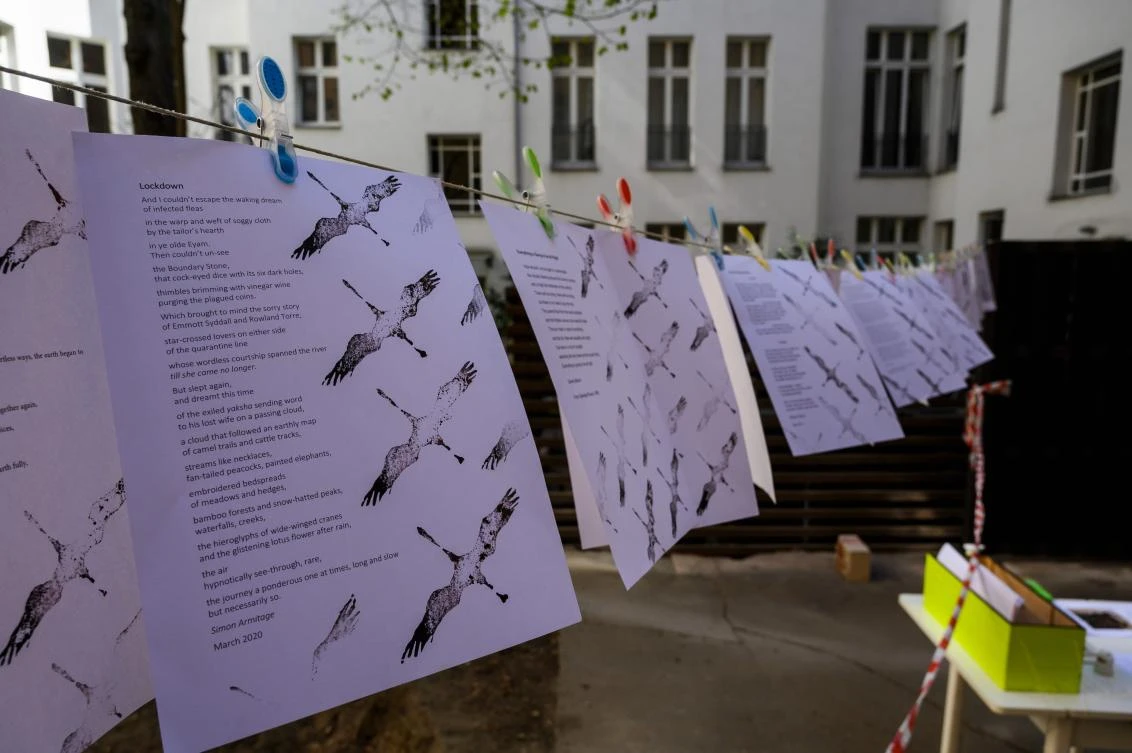 A poem with the title "Lockdown" hangs on a clothes line, part of the "Balconies, Life, Art, Pandemic, and Proximity" exhibition, in Berlin on April 12, 2020, amid a new coronavirus COVID-19 pandemic. Over 30 artists are taking part in the two-day exhibition which calls on "the artistic community living in [Berlin's district of] Prenzlauer Berg to activate / exhibit / inhabit / their windows and balconies on Easter Sunday and Monday". Curated by Ovul Durmusoglu and Joanna Warsza, the exhibition boasts "zero budget, no openings, no crowds, just a proposition of a stroll that would connect dots in solidarity and togetherness". / AFP / John MACDOUGALL