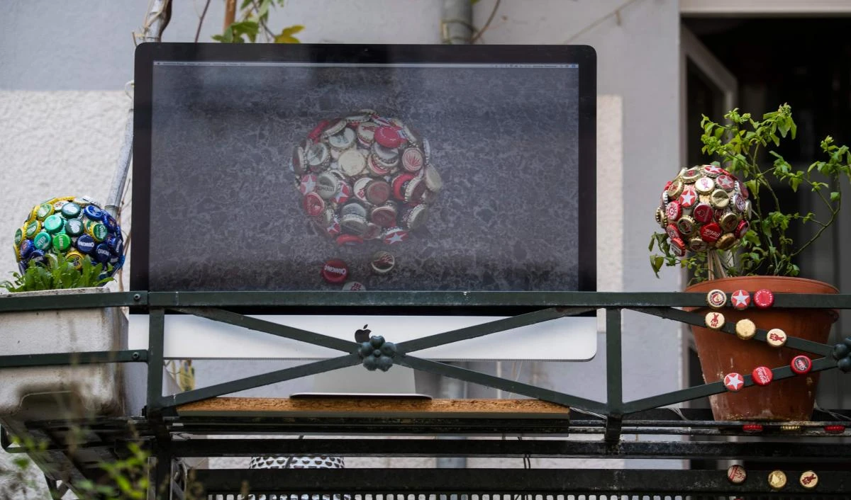 An art installation featuring a video screen, part of the "Balconies, Life, Art, Pandemic, and Proximity" exhibition, is seen in Berlin on April 12, 2020, amid a new coronavirus COVID-19 pandemic. Over 30 artists are taking part in the two-day exhibition which calls on "the artistic community living in [Berlin's district of] Prenzlauer Berg to activate / exhibit / inhabit / their windows and balconies on Easter Sunday and Monday". Curated by Ovul Durmusoglu and Joanna Warsza, the exhibition boasts "zero budget, no openings, no crowds, just a proposition of a stroll that would connect dots in solidarity and togetherness". / AFP / John MACDOUGALL