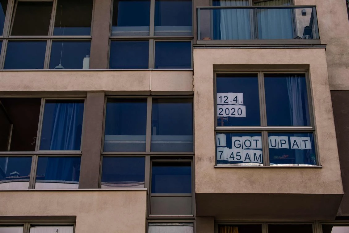 An art installation alluding to the work of Japanese conceptual artist On Karawa, featuring a sign reading: "12,4,2020 I got up at 7:45 am", part of the "Balconies, Life, Art, Pandemic, and Proximity" exhibition, is seen in Berlin on April 12, 2020, amid a new coronavirus COVID-19 pandemic. Over 30 artists are taking part in the two-day exhibition which calls on "the artistic community living in [Berlin's district of] Prenzlauer Berg to activate / exhibit / inhabit / their windows and balconies on Easter Sunday and Monday". Curated by Ovul Durmusoglu and Joanna Warsza, the exhibition boasts "zero budget, no openings, no crowds, just a proposition of a stroll that would connect dots in solidarity and togetherness". / AFP / John MACDOUGALL