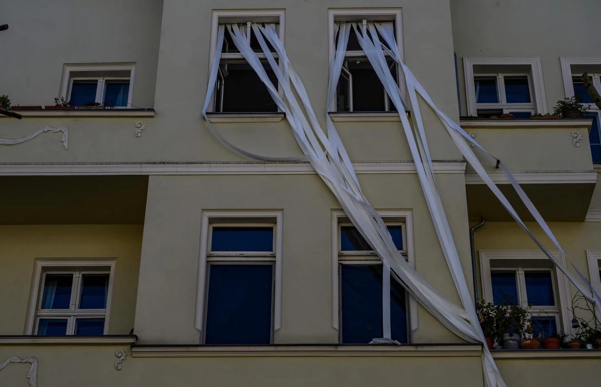 An art installation featuring unfurled rolls of toilet paper, part of the "Balconies, Life, Art, Pandemic, and Proximity" exhibition, is seen in Berlin on April 12, 2020, amid a new coronavirus COVID-19 pandemic. Over 30 artists are taking part in the two-day exhibition which calls on "the artistic community living in [Berlin's district of] Prenzlauer Berg to activate / exhibit / inhabit / their windows and balconies on Easter Sunday and Monday". Curated by Ovul Durmusoglu and Joanna Warsza, the exhibition boasts "zero budget, no openings, no crowds, just a proposition of a stroll that would connect dots in solidarity and togetherness". / AFP / John MACDOUGALL