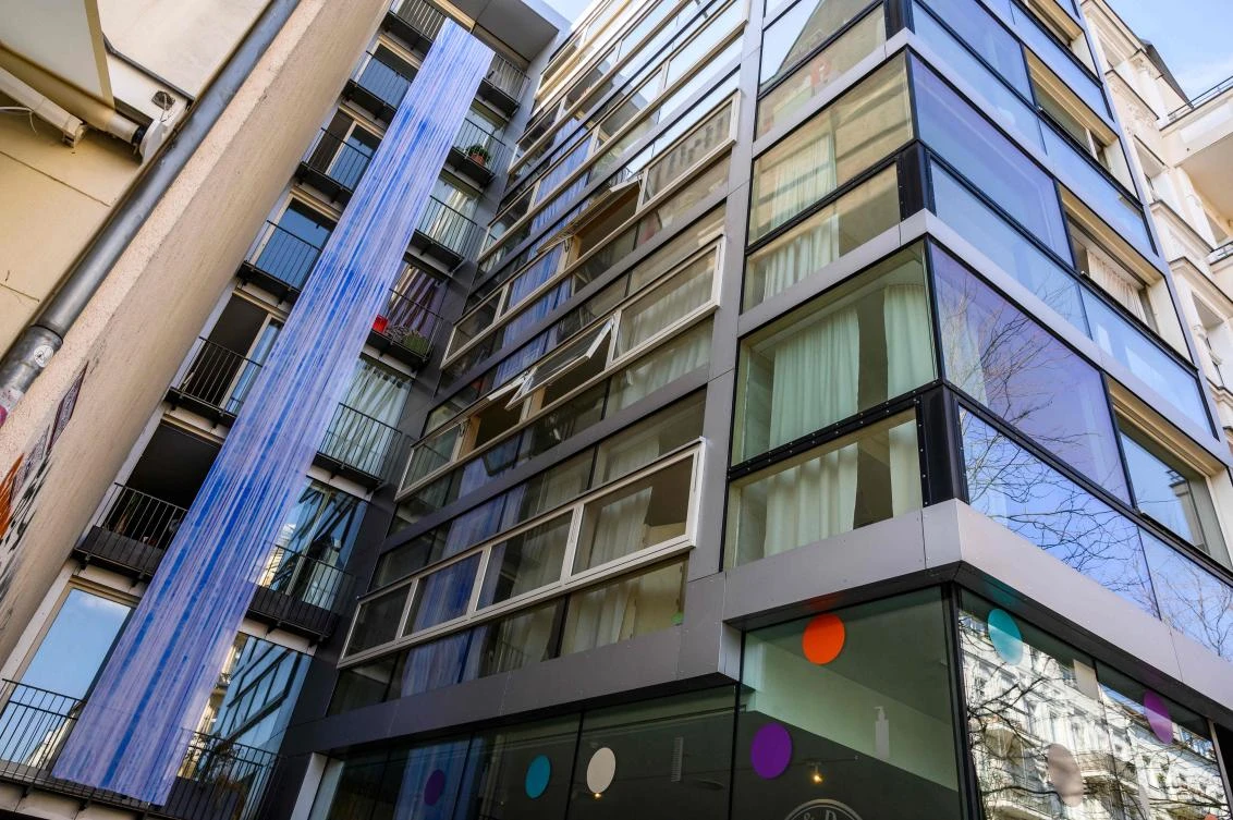 An art installation featuring a strip of fabric hanging from a balcony, part of the "Balconies, Life, Art, Pandemic, and Proximity" exhibition, is seen in Berlin on April 12, 2020, amid a new coronavirus COVID-19 pandemic. Over 30 artists are taking part in the two-day exhibition which calls on "the artistic community living in [Berlin's district of] Prenzlauer Berg to activate / exhibit / inhabit / their windows and balconies on Easter Sunday and Monday". Curated by Ovul Durmusoglu and Joanna Warsza, the exhibition boasts "zero budget, no openings, no crowds, just a proposition of a stroll that would connect dots in solidarity and togetherness". / AFP / John MACDOUGALL