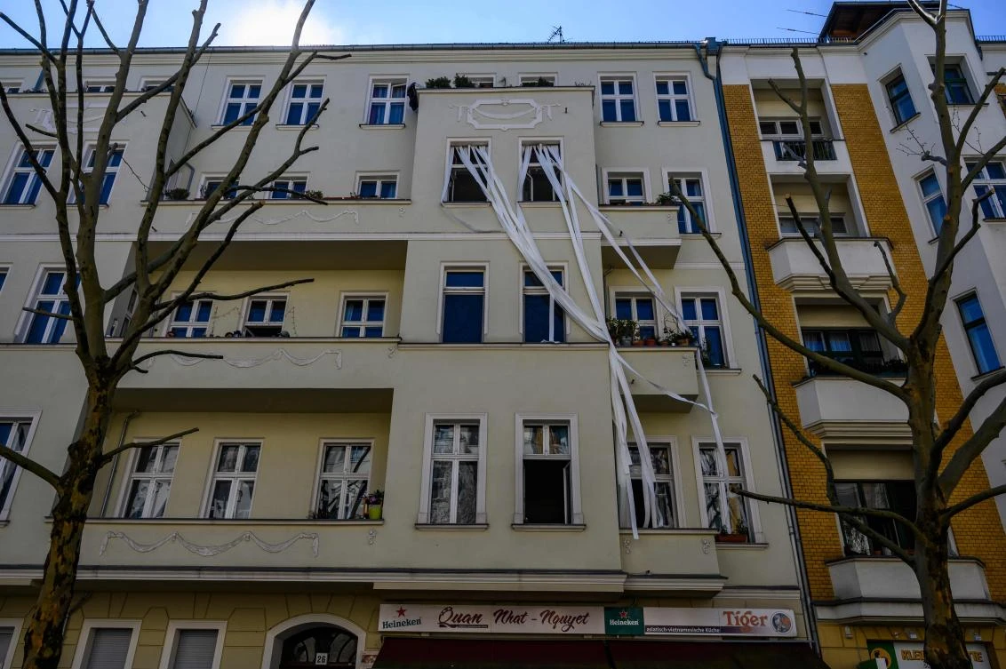 An art installation featuring unfurled rolls of toilet paper, part of the "Balconies, Life, Art, Pandemic, and Proximity" exhibition, is seen in Berlin on April 12, 2020, amid a new coronavirus COVID-19 pandemic. Over 30 artists are taking part in the two-day exhibition which calls on "the artistic community living in [Berlin's district of] Prenzlauer Berg to activate / exhibit / inhabit / their windows and balconies on Easter Sunday and Monday". Curated by Ovul Durmusoglu and Joanna Warsza, the exhibition boasts "zero budget, no openings, no crowds, just a proposition of a stroll that would connect dots in solidarity and togetherness". / AFP / John MACDOUGALL