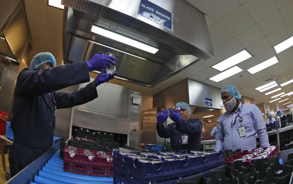 Employees at Doha's Hamad International Airport display measures which have been implemented to prevent the spread of the new coronavirus COVID-19, on March 31, 2020. (AFP)