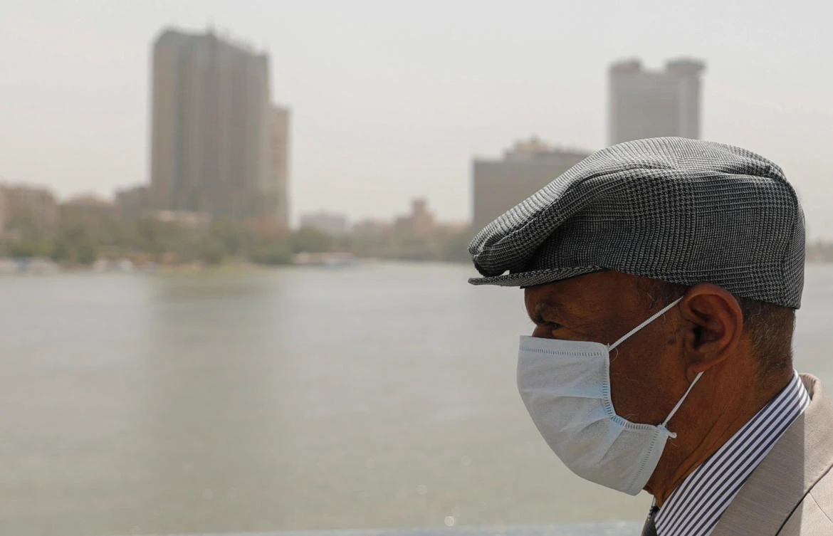 An older man, wearing a protective mask amid concerns over the coronavirus disease (COVID-19), walks on the Qasr el-Nil Bridge across the Nile river in Egyptian capital Cairo, Egypt March 31, 2020. (Reuters)