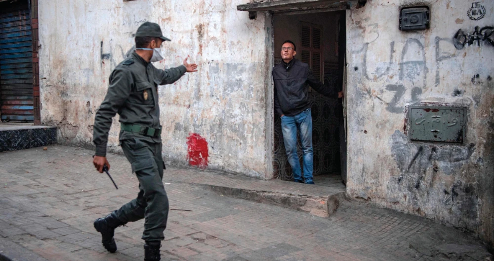 A policeman instructs a man to remain at home as a measure against the spread of the coronavirus pandemic. (AFP)