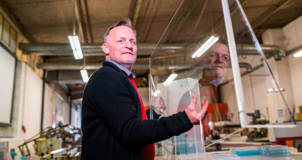 Riesner owner Claus Mueller joins employees churning out plexiglass virus shields in his Wiesbaden factory. (AFP)