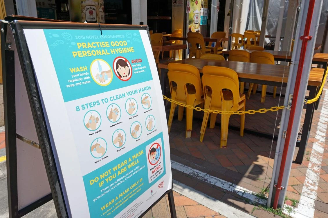 A sign promoting good hygiene habits as a preventive measure against the spread of the coronavirus is displayed in Chinatown in Singapore on April 1, 2020. (AFP)