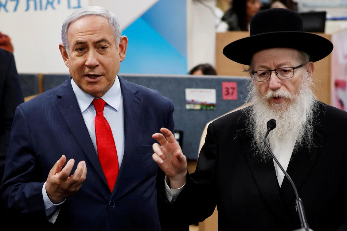 Israel’s health minister Yaakov Litzman, right, had frequent contact with Prime Minister Benjamin Netanyahu, left, and other top officials. (Reuters)