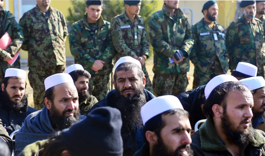Released Taliban prisoners sit on chairs as they listen during a ceremony in Pul-e-Charkhi jail on the outskirts of Kabul on January 4, 2013. (AFP)