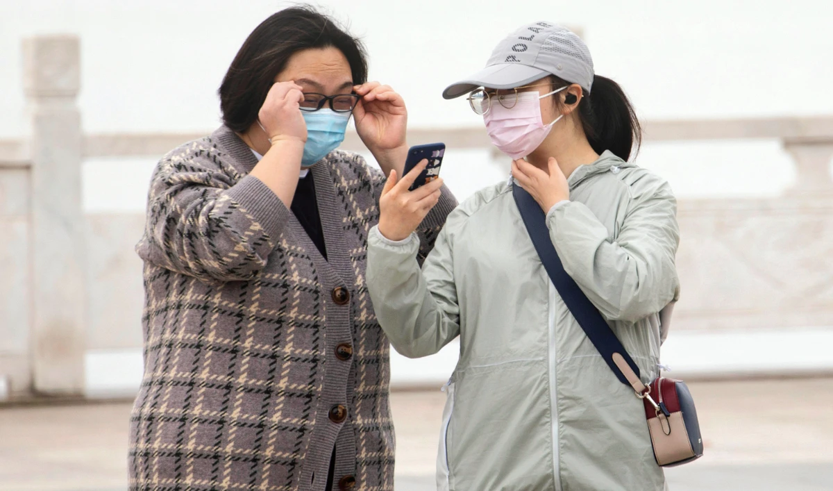 Citizens in Wuhan in central China. A green symbol on a smartphone screen is required to board a subway, check into a hotel or enter the city. (AP)