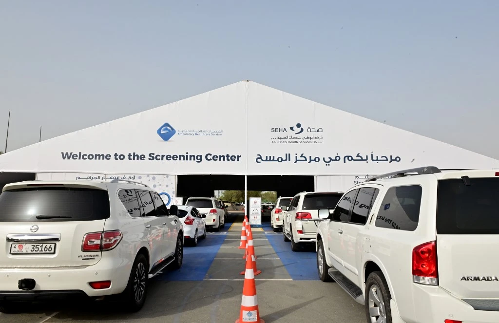 Cars line up as people wait to enter a drive thru testing center for the coronavirus in Abu Dhabi on April 2, 2020. (AFP)