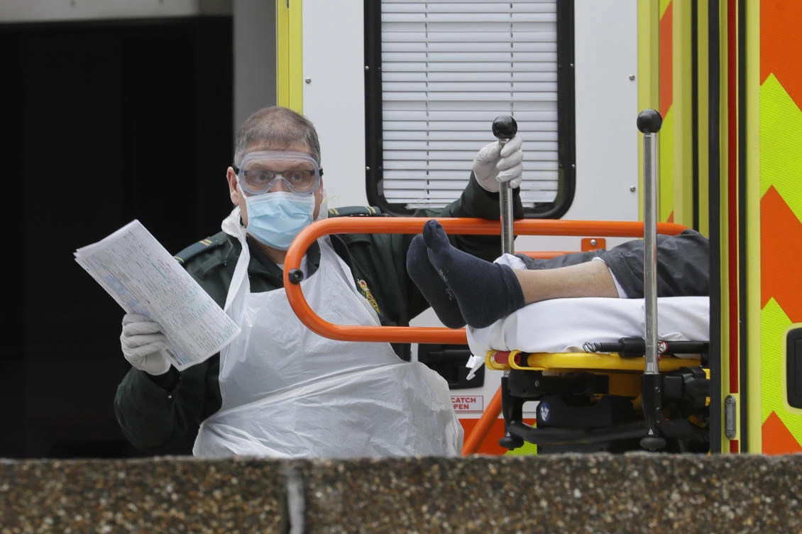 A patient is helped from an ambulance upon arrival at St. Thomas’ Hospital in London in this March 31, 2020 file photo. (AP)