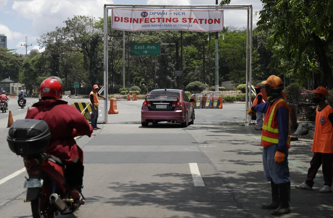 Vehicles are sprayed with disinfectants along a road during a community quarantine to help curb the spread of the new coronavirus in the Philippines on Wednesday, April 1, 2020.(AP)