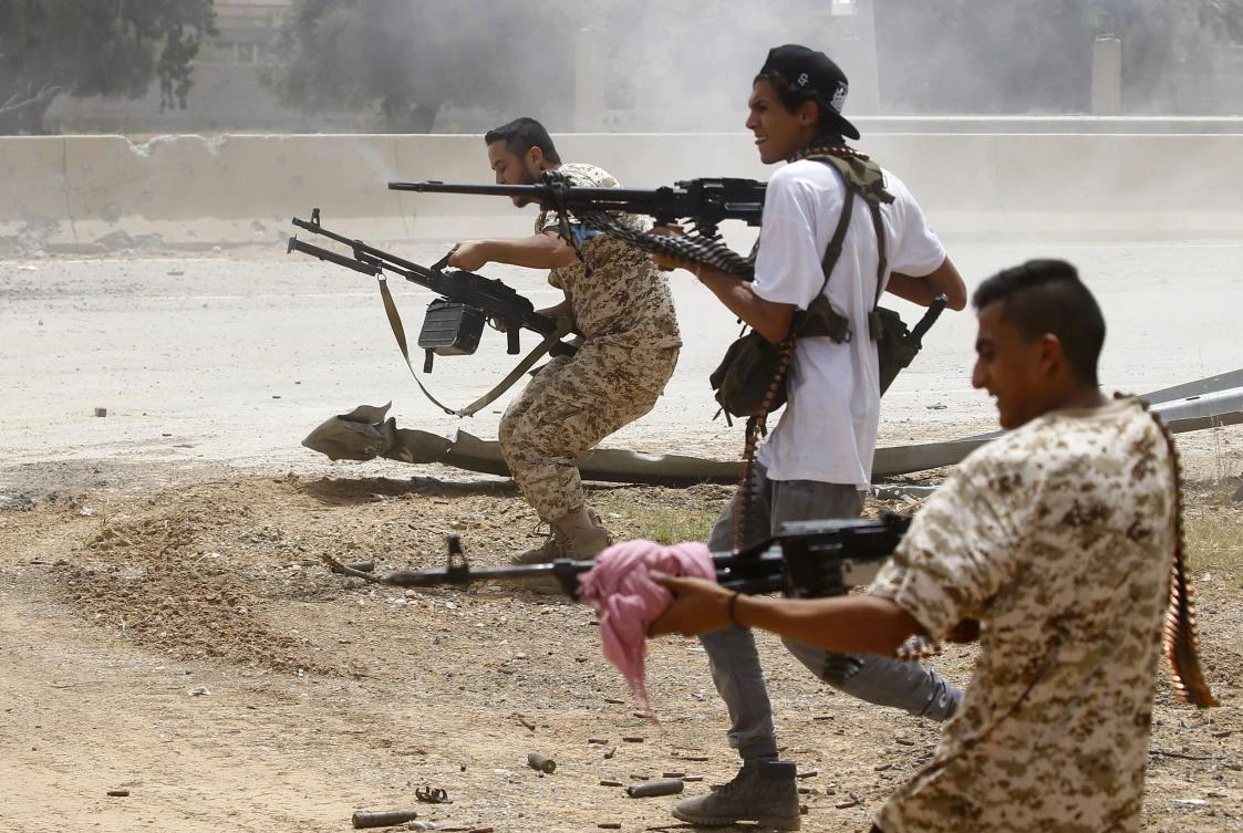 Fighters loyal to the UN-recognized Government of National Accord (GNA) open fire from their position in the Al-Sawani area south of the Libyan capital Tripoli during clashes with forces loyal to strongman Khalifa Haftar. (AFP/Mahmud Turkia)