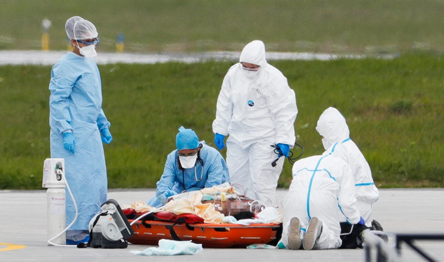 Medical employees on Friday prepare a patient infected with Covid-19 on a stretcher to be evacuated by helicopter to a hospital outside Paris region. (AFP)