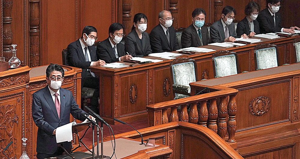 Japanese leader Shinzo Abe says the stimulus plan to counter coronavirus will exceed the $525 billion package compiled after the 2008 global financial crisis. (AP)