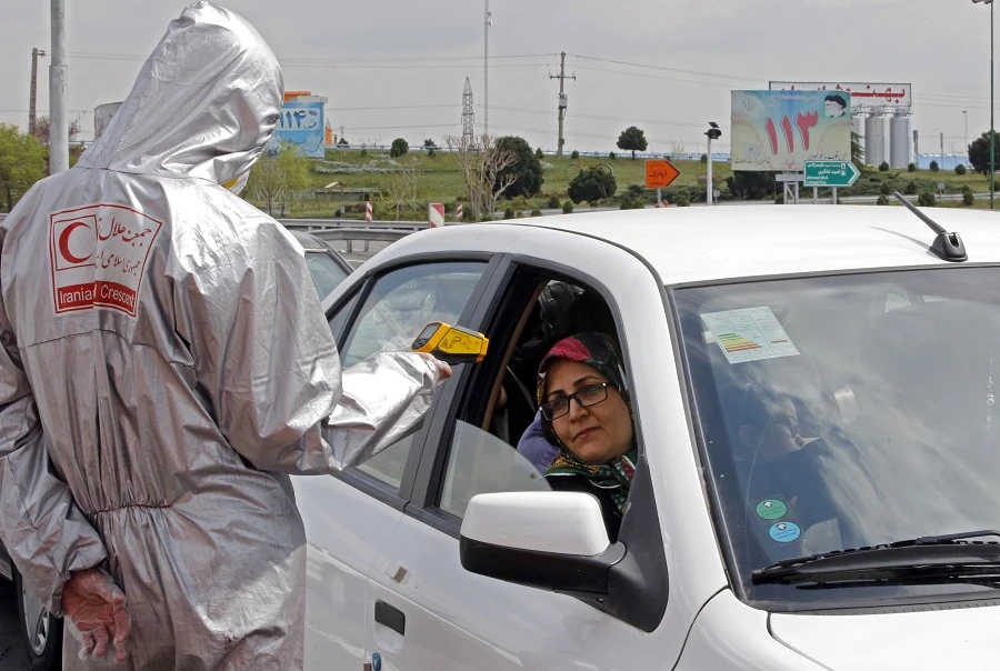Members of the Iranian Red Crescent test people for coronavirus Covid-19 symptoms, as police blocked Tehran to Alborz highway to check every car following orders by the Iranian government, outside Tehran on March 26, 2020. (File/AFP)
