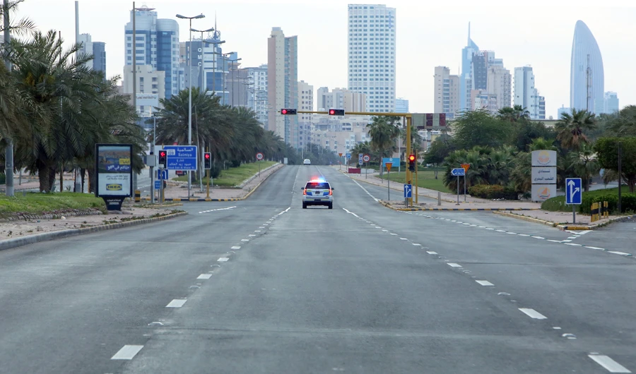 A Kuwaiti police car patrols deserted streets in Kuwait city, on March 23, 2020, a day after authorities declared a nationwide curfew amid the COVID-19 coronavirus pandemic. (AFP)