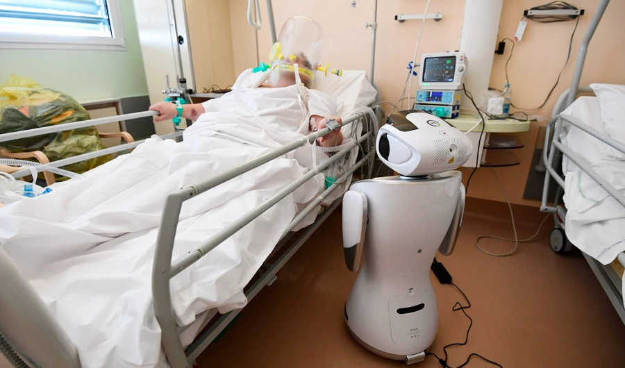 One of the six robots of the Circolo di Varese hospital checks a patient. (AP)