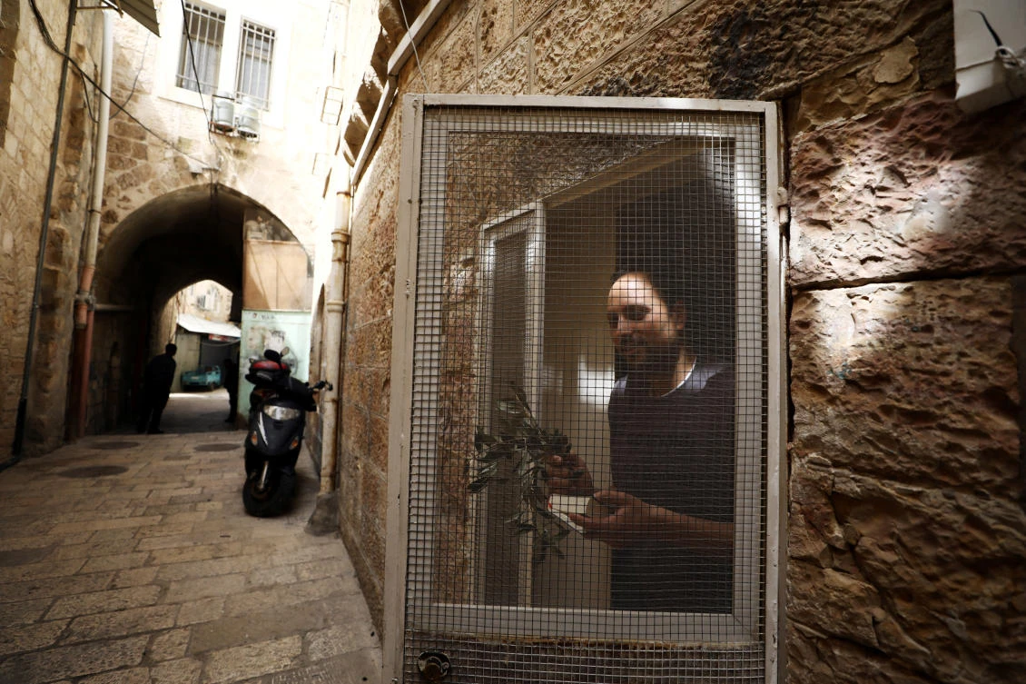 Members of the Latin Patriarchate distributed Olive branches to Christian residents on Palm Sunday, during Holy Week amid the coronavirus disease (COVID-19) outbreak, in Jerusalem's Old City April 5, 2020. (Reuters)