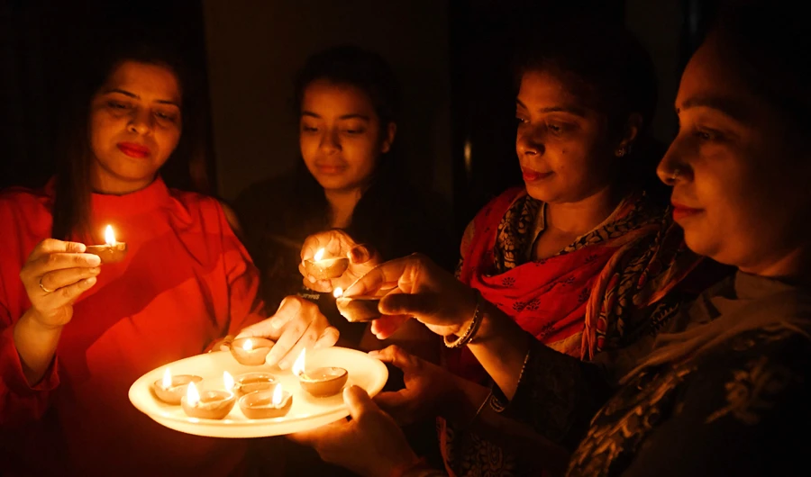 Residents light diyas or oil lamps outside their home to observe a nine-minute vigil called by India’s Prime Minister in the fight against the coronavirus pandemic in Amritsar on Sunday. (AFP)