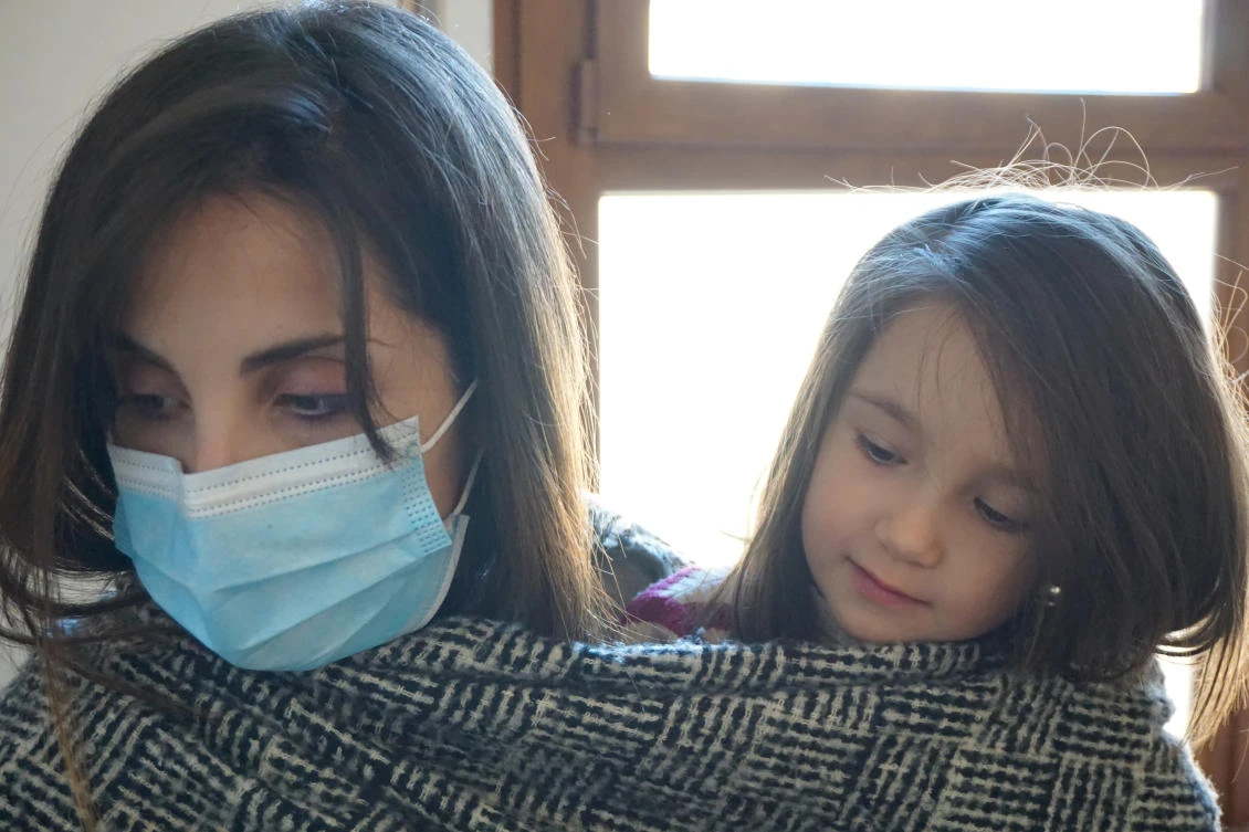 Italian doctor Cecilia Bartalena, 35, hugs her 4-year-old daughter Petra Marianelli, after returning home from a shift looking after COVID-19 patients in Cisanello hospital, Pisa, Italy. (Reuters)