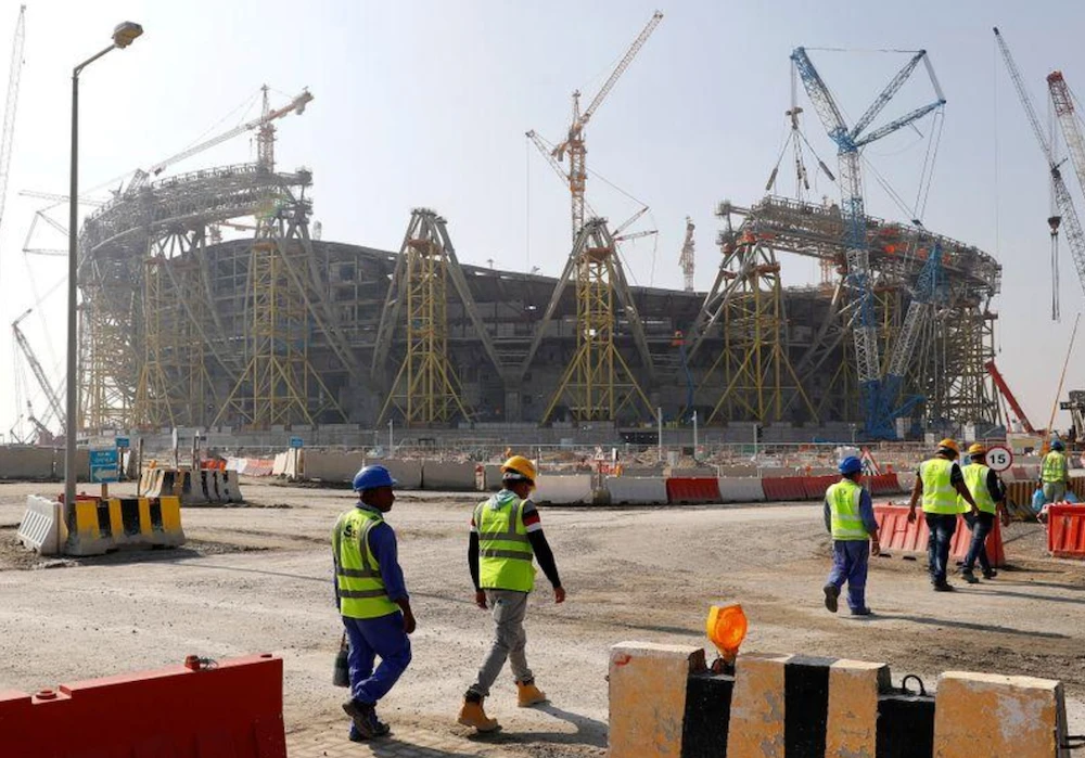 Workers walk towards the construction site of the Lusail stadium which will be build for the upcoming 2022 Fifa soccer World Cup during a stadium tour in Doha, Qatar. (Reuters/File Photo)