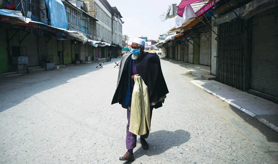 A Kabul market vendor wears a face mask for protection. (AFP)