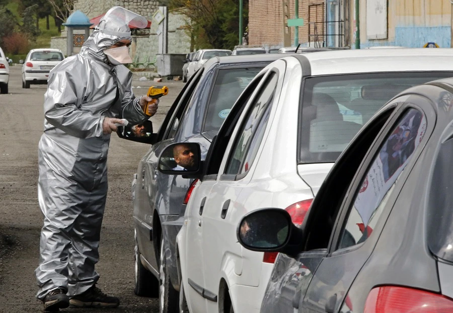 Members of the Iranian Red Crescent test people for coronavirus Covid-19 symptoms, as police blocked Tehran to Alborz highway to check every car following orders by the Iranian government, outside Tehran on March 26, 2020. (File/AFP)