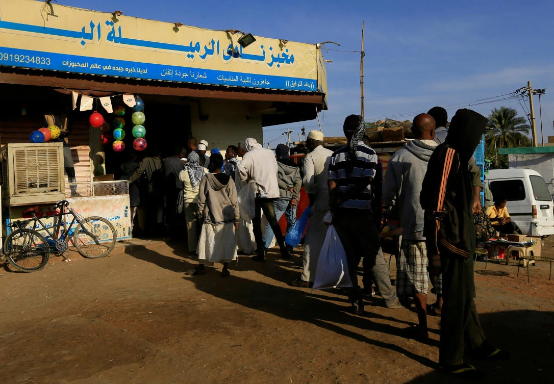 Customers queue to buy bread at a bakery in Khartoum, Sudan. (Reuters)