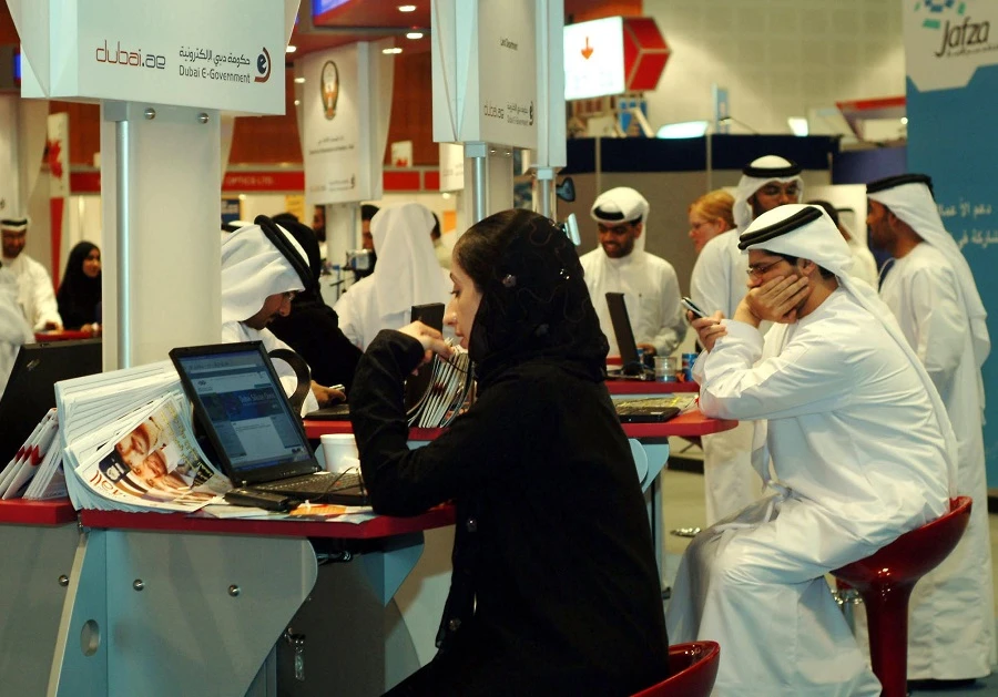 Emiratis work at the Middle East's largest technology exhibition, GITEX, which opened in Dubai 03 Ocotber 2004. (File/AFP)