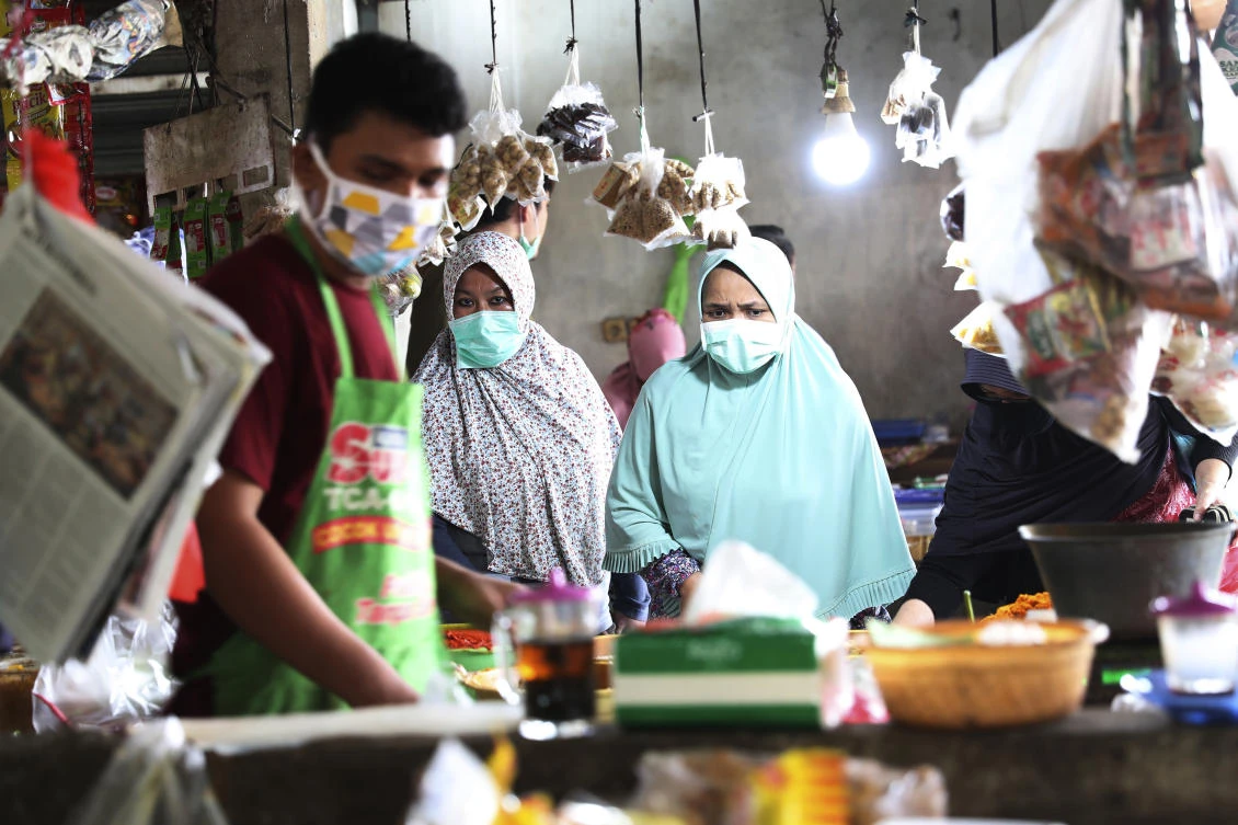 Above, people wear masks at a traditional market in Jakarta, Indonesia on Friday, April 10, 2020. (AP)