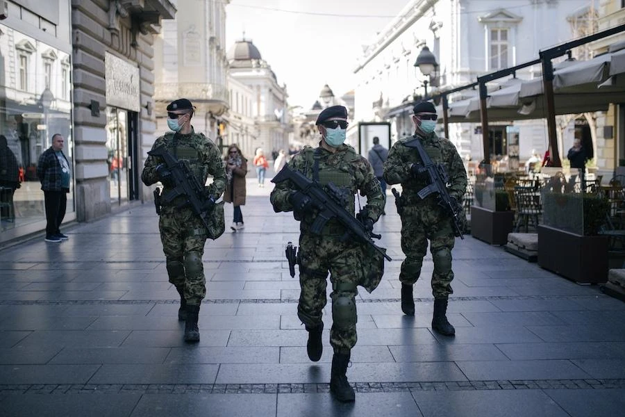 Serbian army soldiers wearing gloves and face masks as preventive measures against COVID-19 (novel Coronavirus), patrol on one of the main pedestrian streets in Belgrade on March 17, 2020. (AFP)