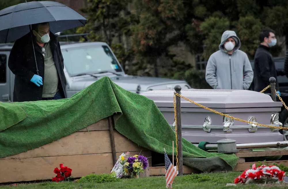 Mourners attend a funeral at The Green-Wood Cemetery, amid the COVID-19 outbreak in the Brooklyn, New York, on April 9, 2020. (REUTERS/Brendan McDermid)