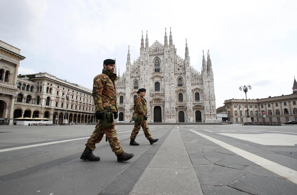 In this March 22, 2020 file photo, Italian soldiers patrol the empty square facing the Duomo gothic cathedral, Milan, Italy. (AP)