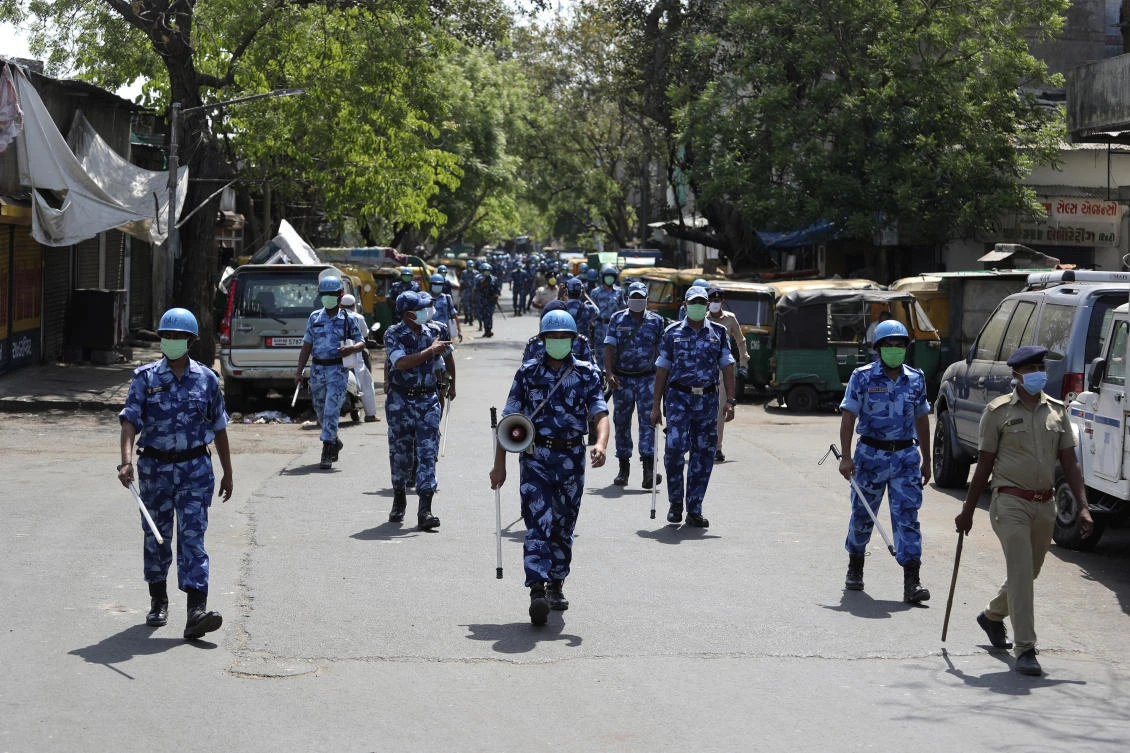 Rapid Action Force (RAF) personnel patrol a street during lockdown to control the spread of the new coronavirus in Ahmedabad, India, Saturday, April 11, 2020. (AP)