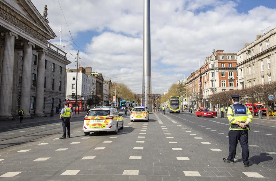 Irish police officers, or Garda officers, talk with members of the public as they conduct checks on pedestrians and motorists in Dublin city centre on April 8, 2020, as life in Ireland continues during the nationwide lockdown to combat the novel coronavirus pandemic. (AFP)
