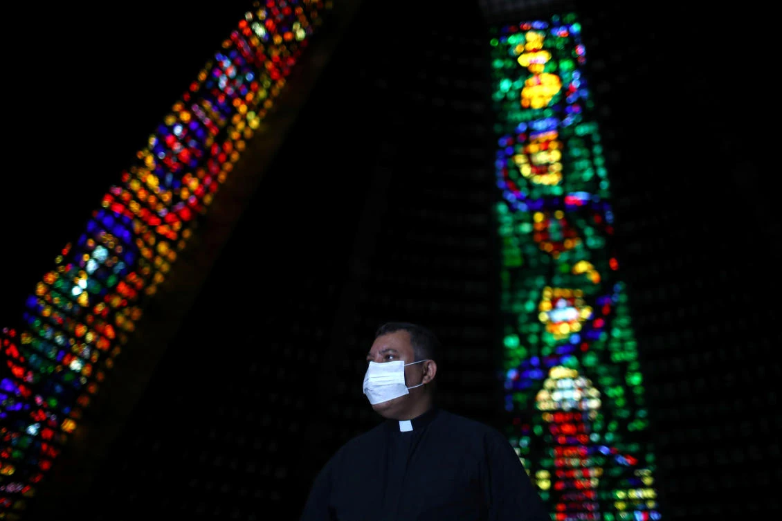 Priest Claudio Dos Santos wearing a face mask is seen after celebrating via livestream the Easter Sunday Mass at the Sao Sebastiao Cathedral, which is closed amid the coronavirus disease (COVID-19) outbreak, in Rio de Janeiro, Brazil April 12, 2020. (Reuters)
