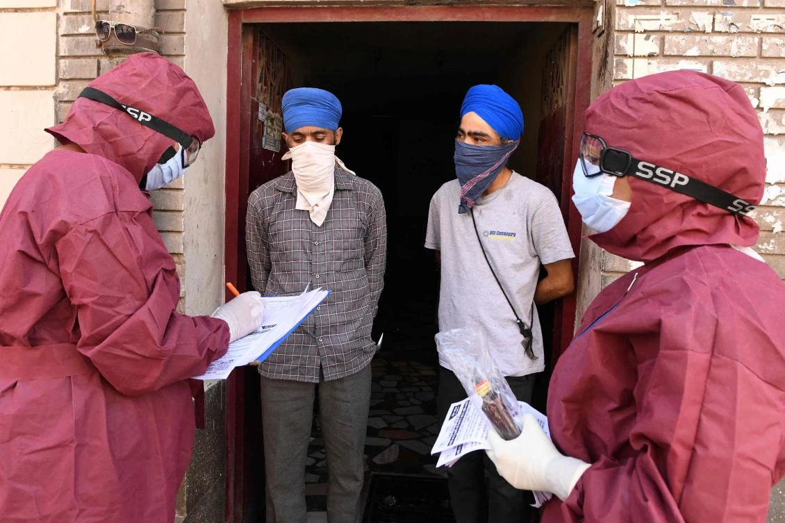 Medical staff wearing protective gears visit a residential area to screen residents in the wake of COVID-19 coronavirus outbreak, during a government-imposed nationwide lockdown as a preventive measure against the COVID-19 coronavirus in Amritsar on April 12, 2020. (AFP)