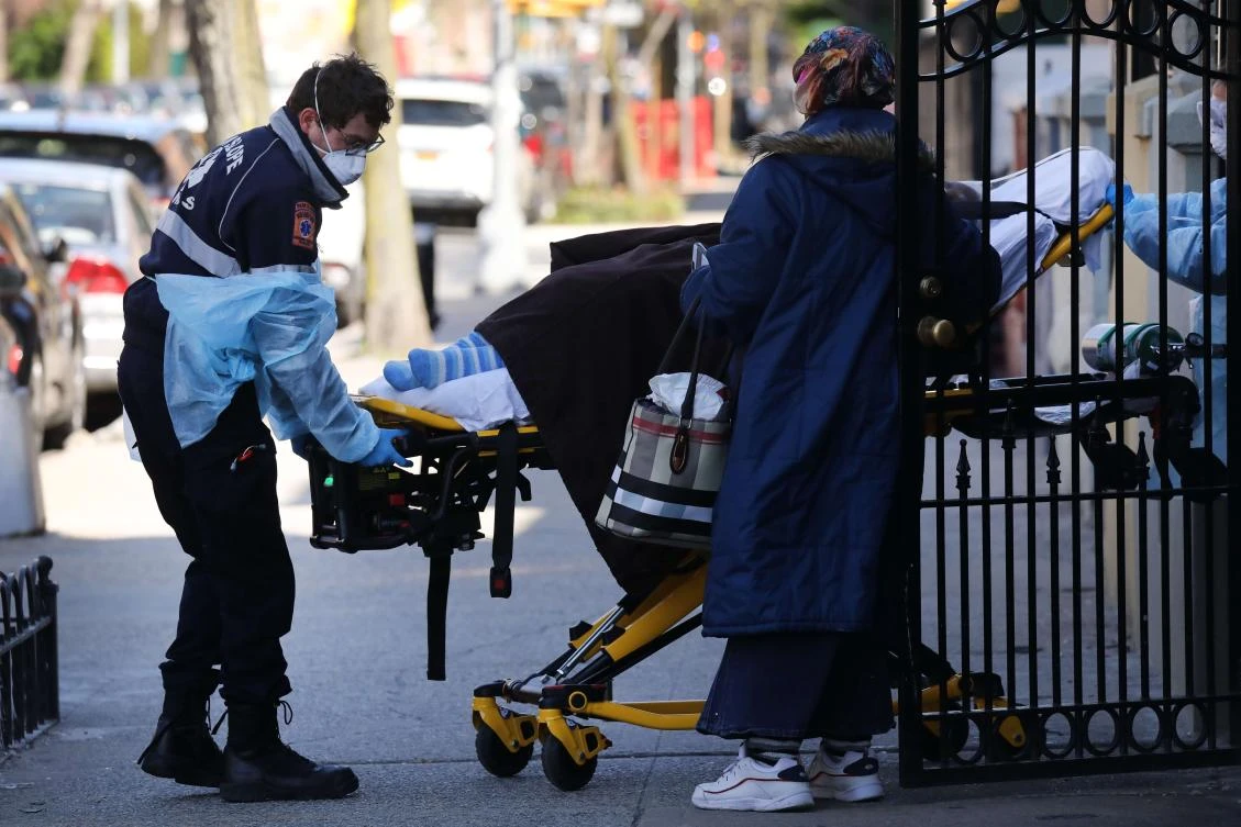 Above, health workers transfer a patient to an ambulance on April 11, 2020 in the Brooklyn borough of New York City. (Getty Images/AFP)