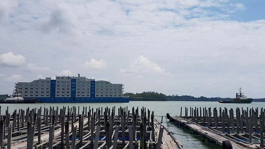 A tugboat pulls the Bibby Renaissance floating hotel meant to house healthy migrant worker in Singapore, April 11, 2020. (Courtesy of Sea Farmers at Ubin via Reuters)