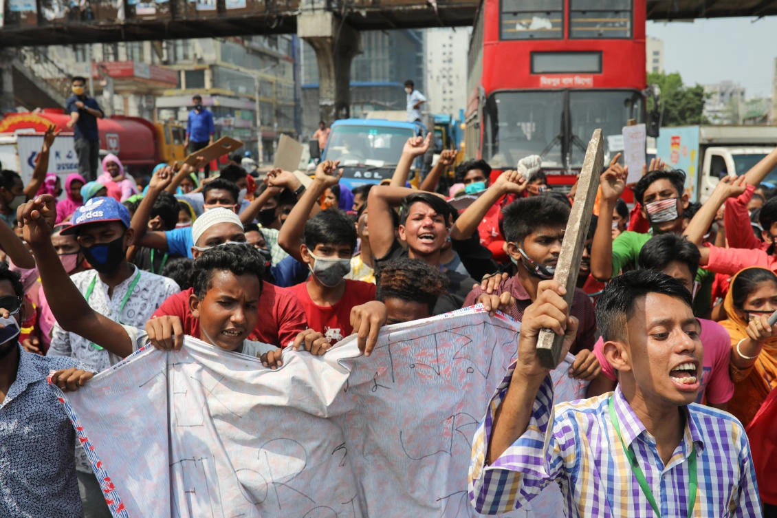 Garment workers block a road demanding their due wages during the lockdown amid concerns over the coronavirus disease (COVID-19) outbreak in Dhaka, (Reuters)