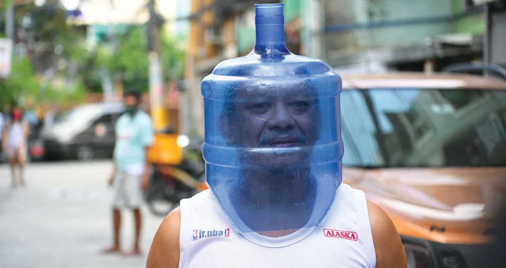 A resident in Manila uses an improvised face shield to protect him from the coronavirus pandemic. (AFP)