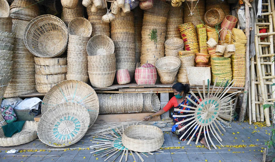 A woman selling bamboo baskets at her roadside stall in Bangalore on Monday. (AFP)
