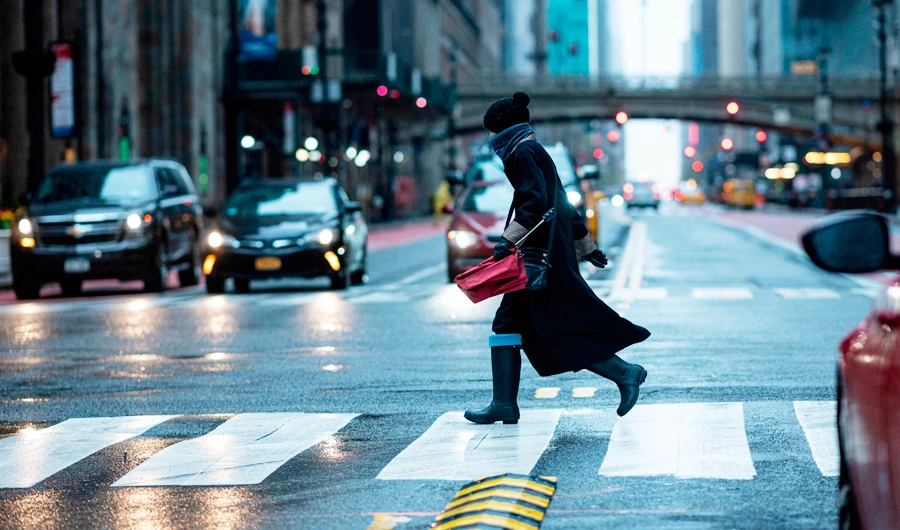 A woman crosses 42nd street on April 13, 2020 in New York City. New York's governor declared Monday that the "worst is over" for its coronavirus outbreak, despite deaths passing 10,000, as several states began devising a plan to reopen their shuttered economies. (AFP)