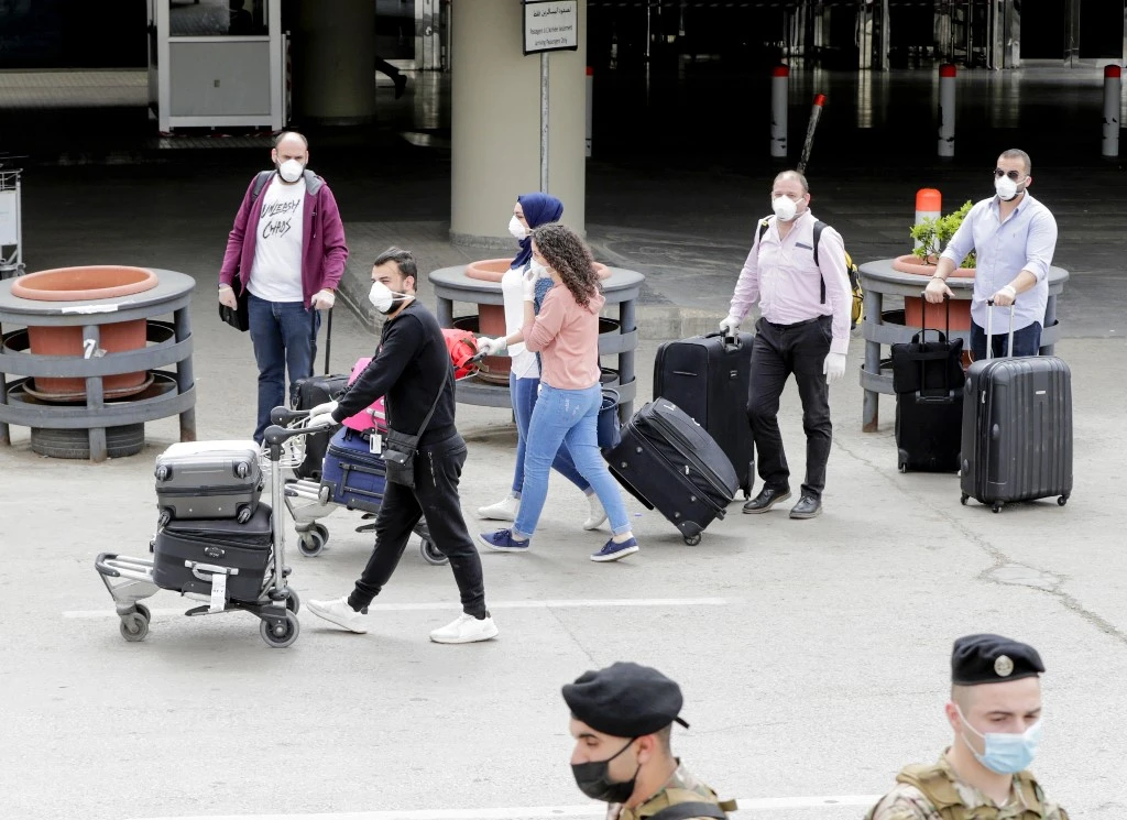 Above, Lebanese nationals repatriated from Saudi Arabia arrive at the Beirut international airport on April 5, 2020. (AFP)
